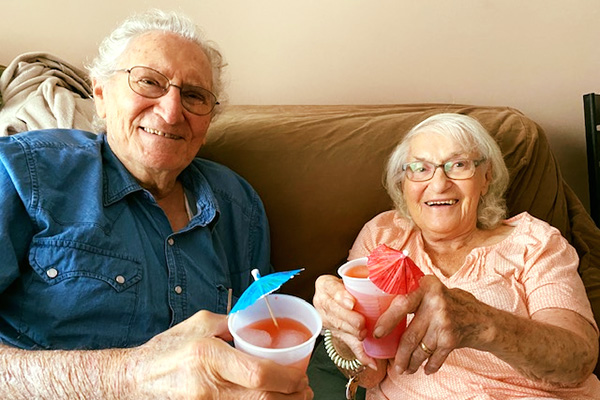 couple cheersing their cocktails